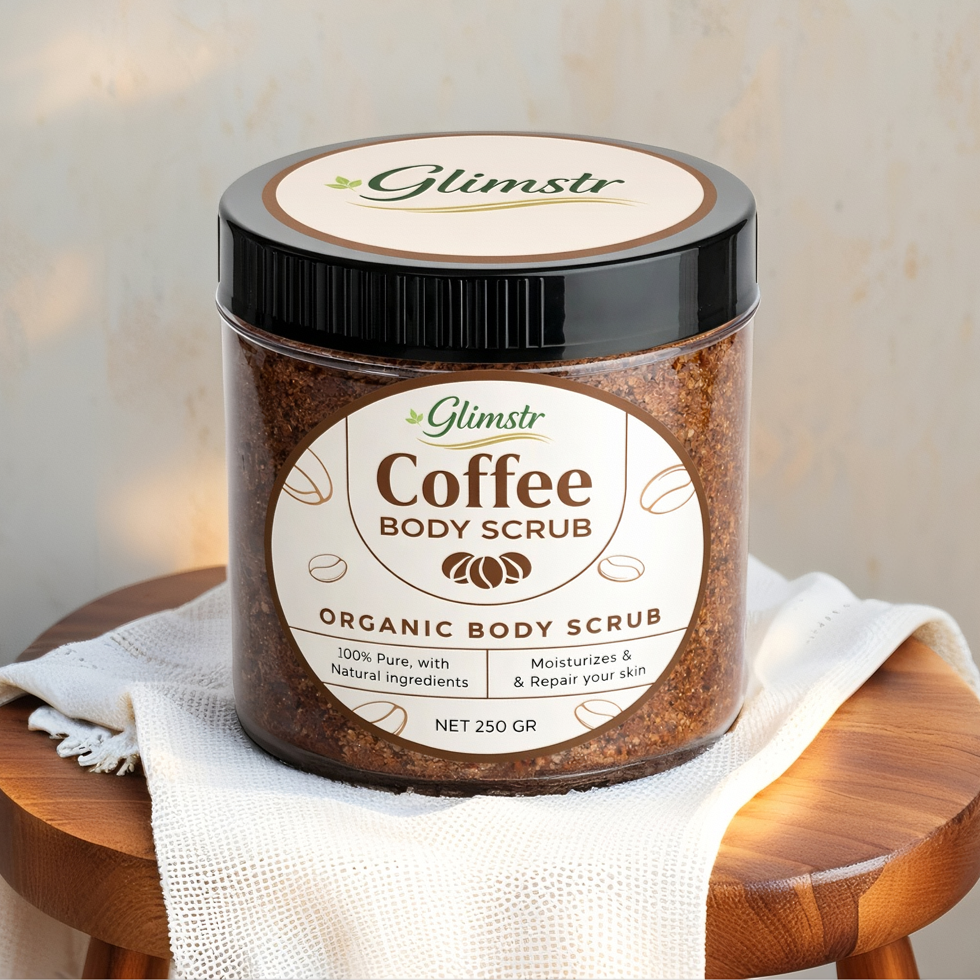 Jar of Glimstr Coffee Body Scrub on a wooden stool with a soft background