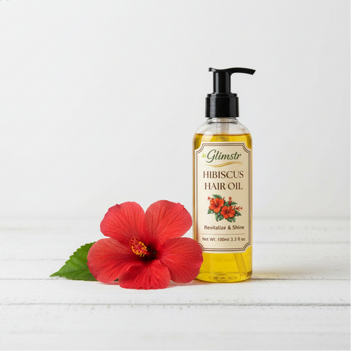 Glimstr hibiscus hair oil bottle with a red flower on a white background