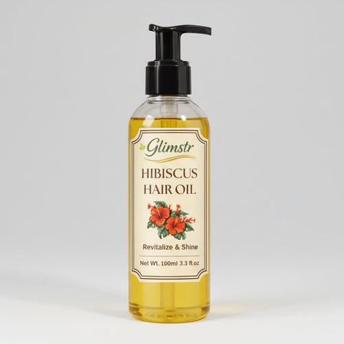 Bottle of Glimstr Hibiscus Hair Oil on a white background